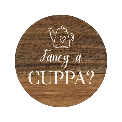 Round wooden coaster with 'fancy a cuppa?' white text and teapot illustration.