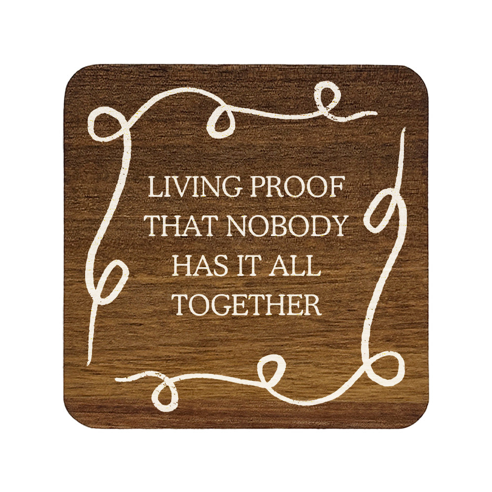 Square wooden coaster with quote 'Living proof that nobody has it all together' in white lettering.