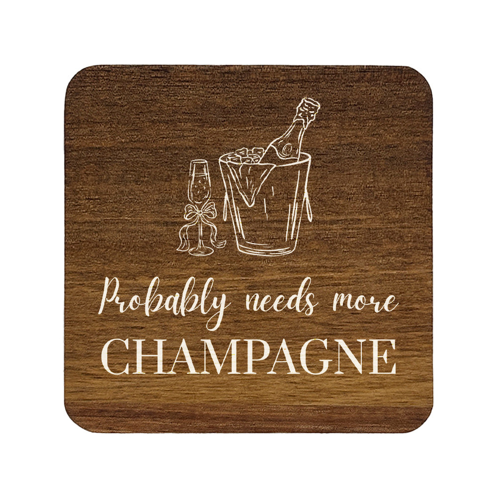 Square wooden coaster with champagne design and text 'Probably needs more CHAMPAGNE' on a white background