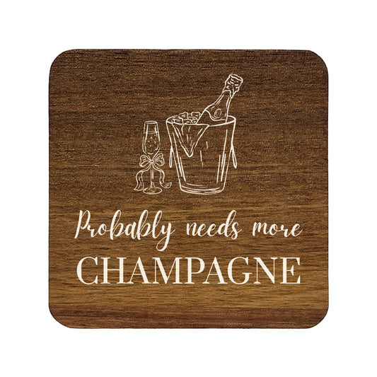 Square wooden coaster with champagne design and text 'Probably needs more CHAMPAGNE' on a white background