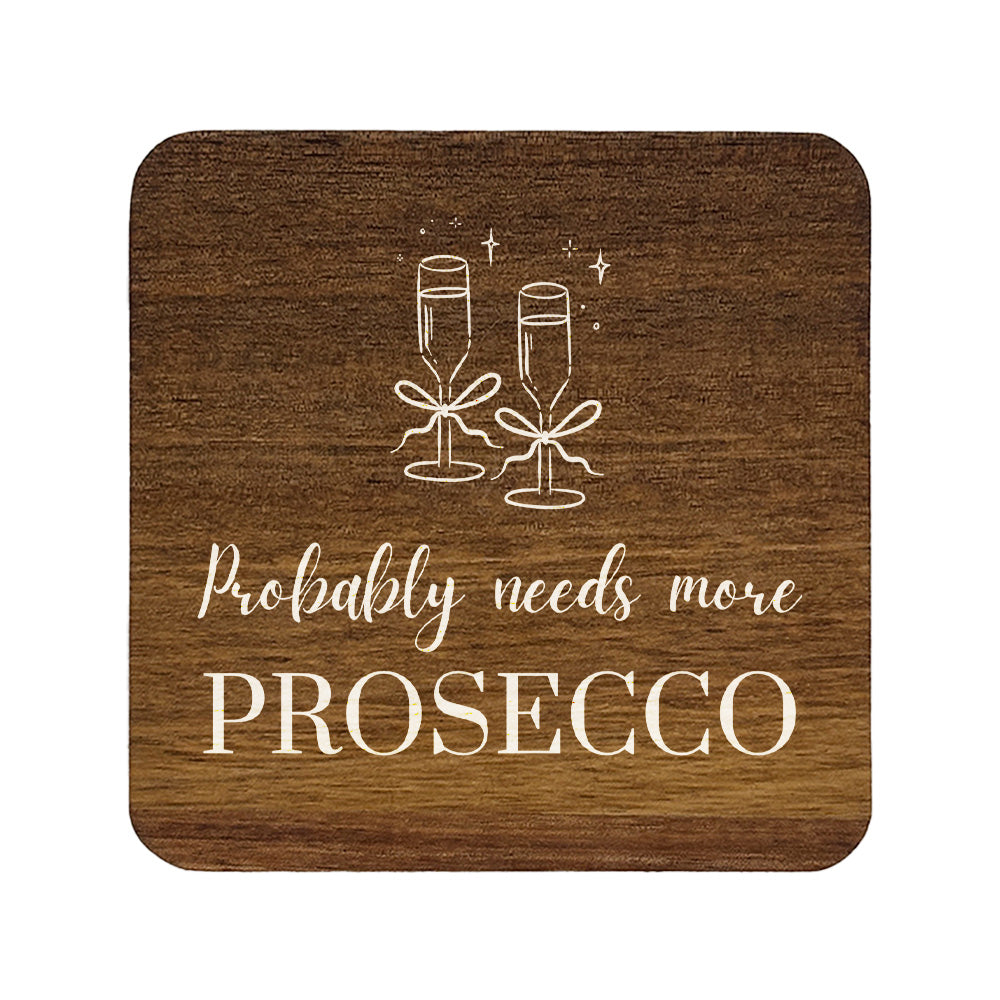 Square wooden coaster with champagne glasses and text 'Probably needs more Prosecco' on a white background