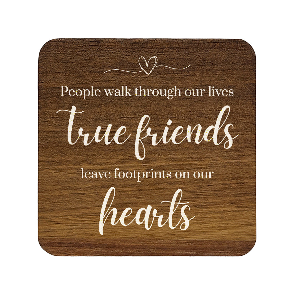Square wooden coaster with quote 'People walk through our lives, true friends leave footprints on our hearts' in white text.