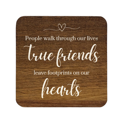 Square wooden coaster with quote 'People walk through our lives, true friends leave footprints on our hearts' in white text.