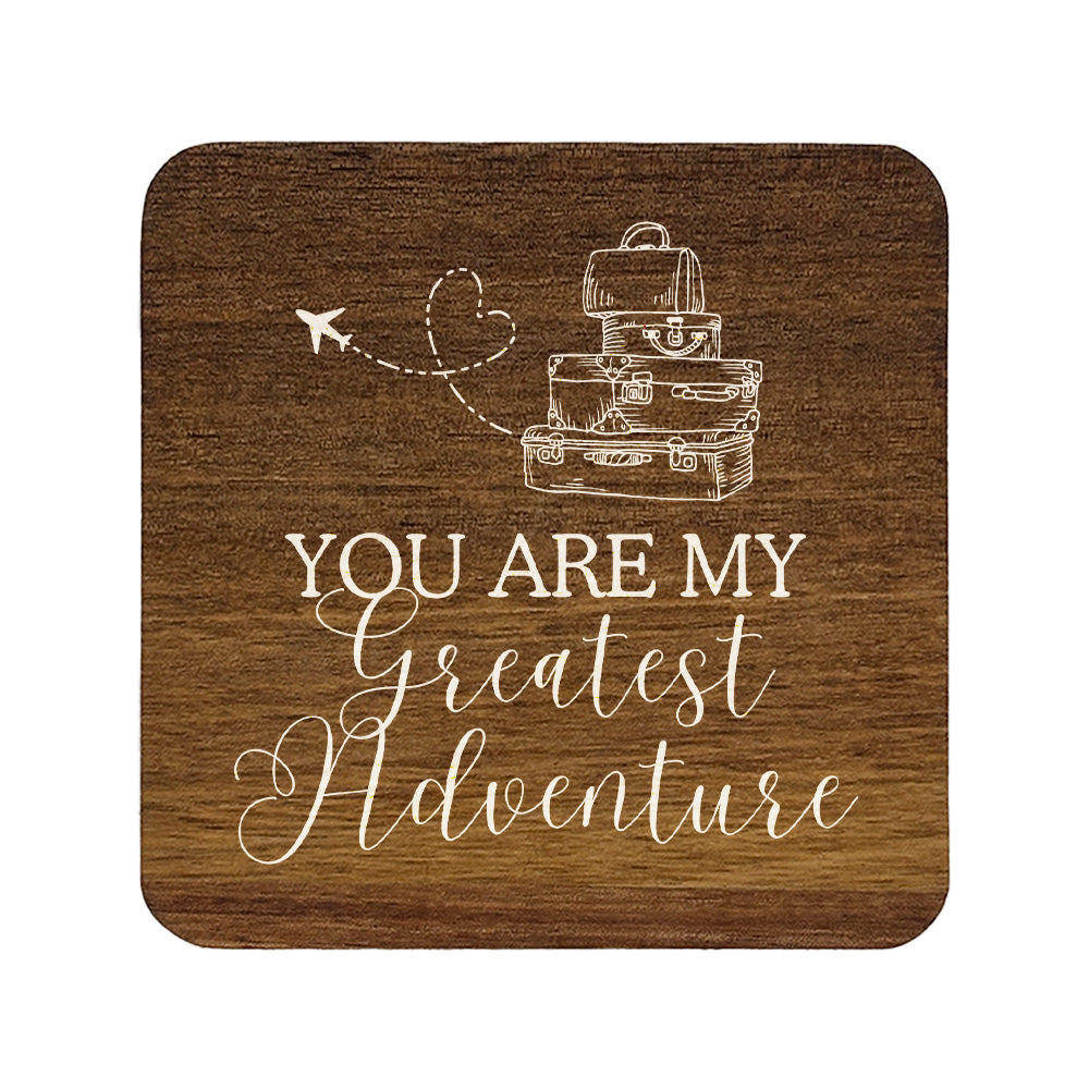 Square wooden coaster with 'you are my greatest adventure' quote in white text with suitcase and aeroplane illustration.