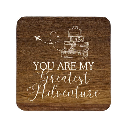 Square wooden coaster with 'you are my greatest adventure' quote in white text with suitcase and aeroplane illustration.