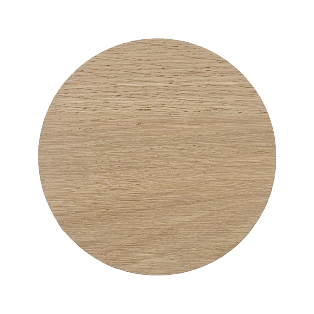 The back of a round wooden coaster with a natural finish on a white background