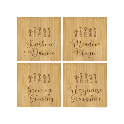 A set of 4 bamboo wood coasters decorated with inspirational quotes.