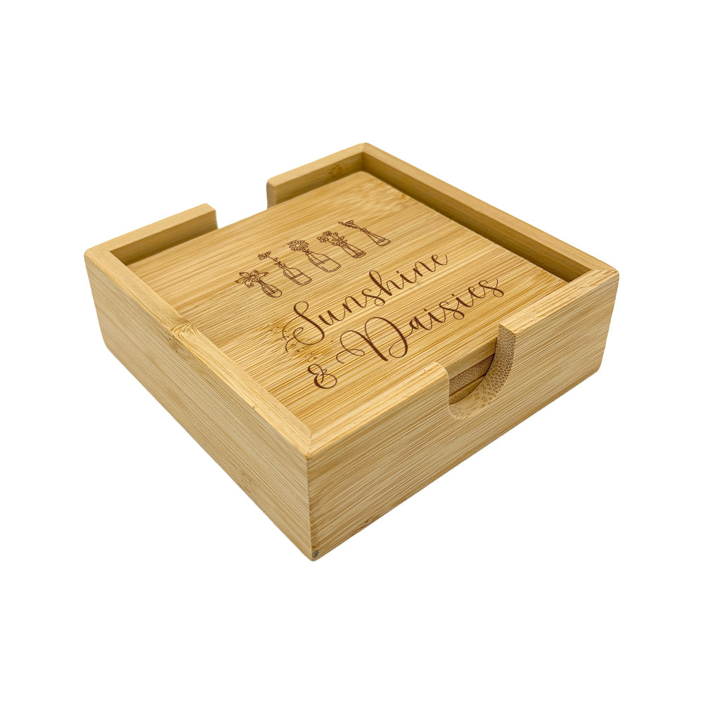 A set of 4 bamboo wood coasters decorated with inspirational quotes and stored in a matching bamboo box.