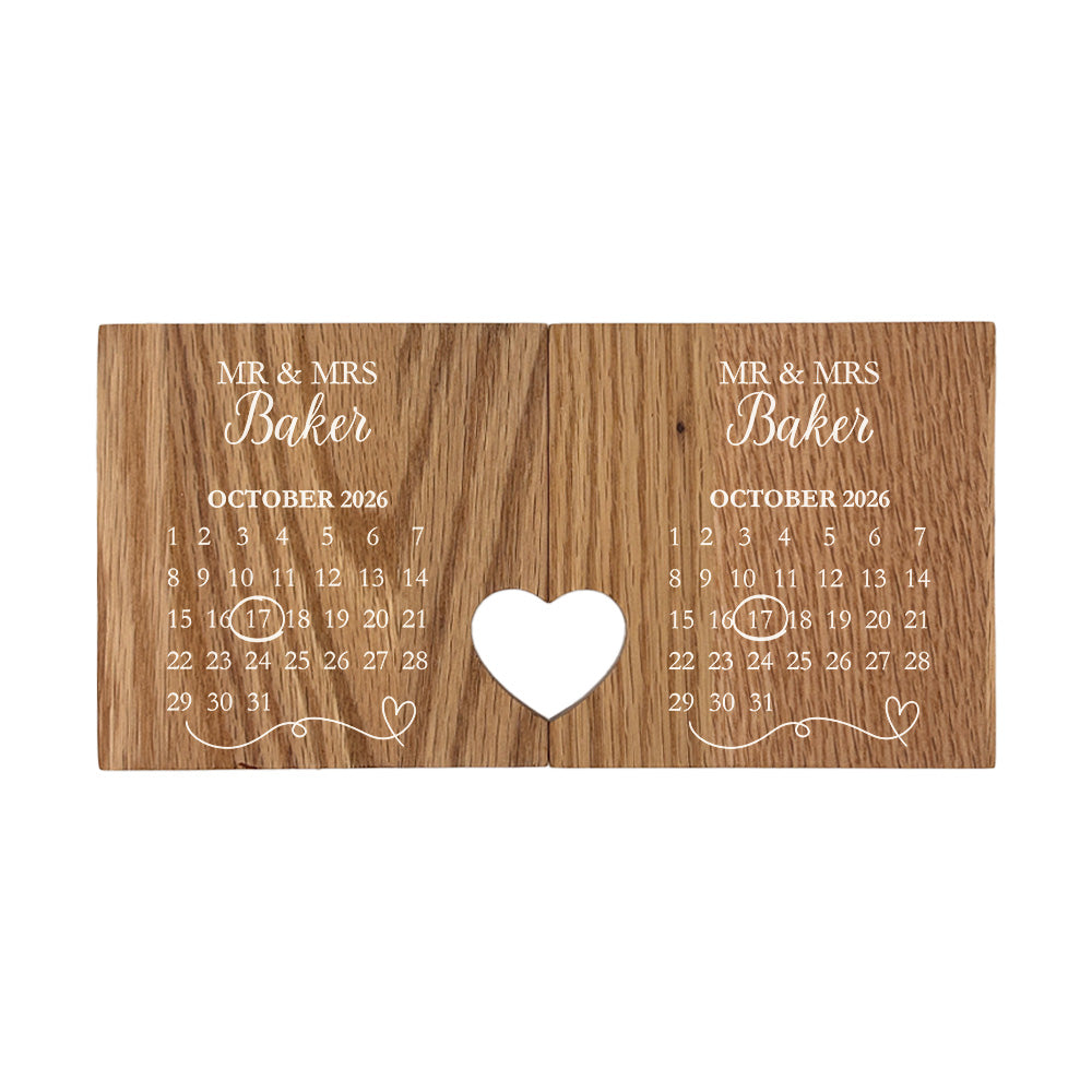 A set of 2 oak coasters personalised with a wedding or anniversary calendar and the couple's name in white text. When placed together a cut-out on each of the coasters forms a heart.