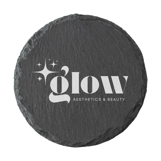 A round dark grey slate coaster personalised with a white printed logo for a beauty salon and aesthetics clinic. Your logo here.