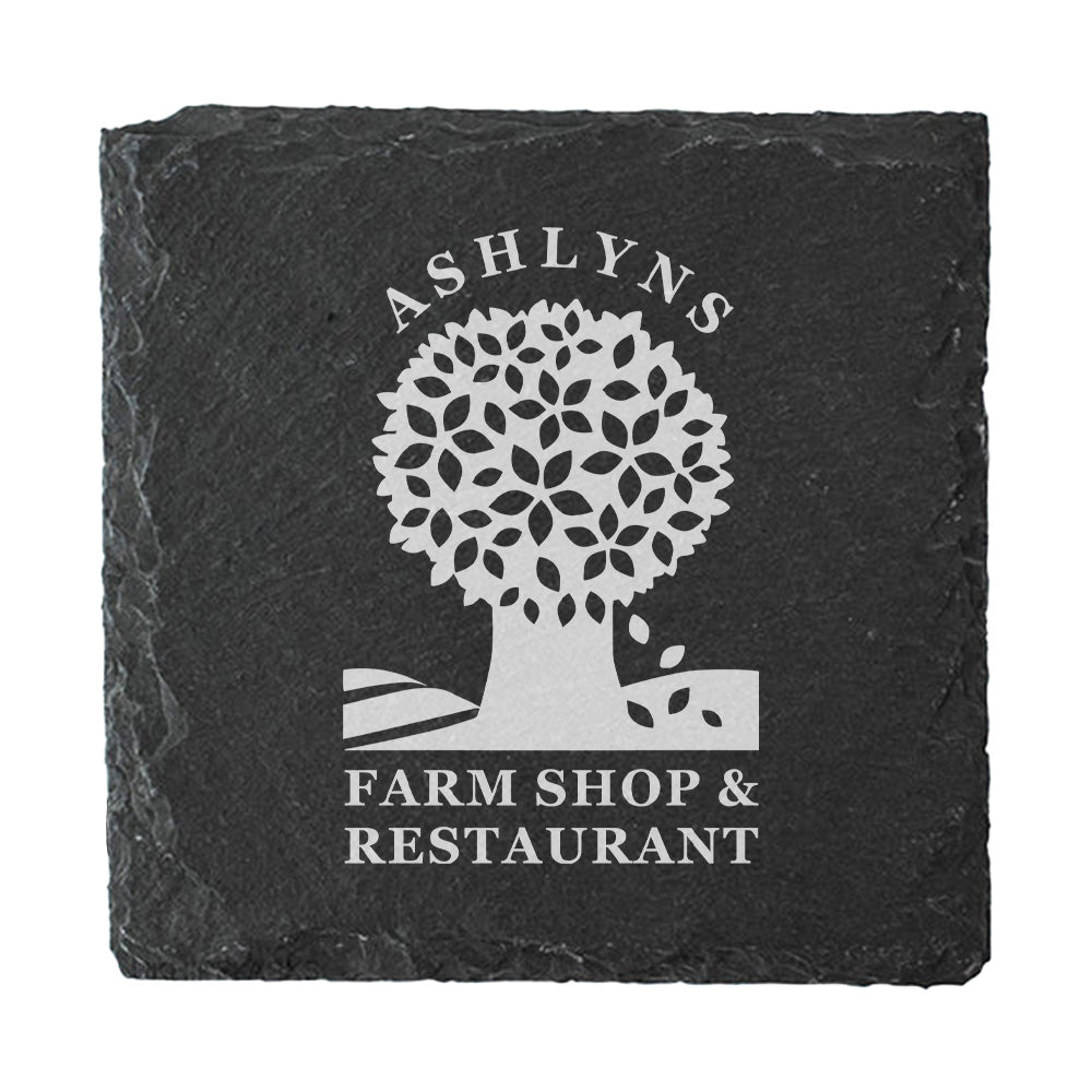 A square dark grey slate coaster personalised with a farm shop business logo in white. Your logo here.