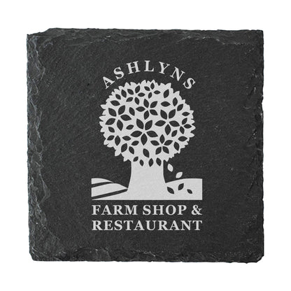 A square dark grey slate coaster personalised with a farm shop business logo in white. Your logo here.