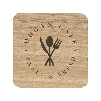 A square wooden coaster with rounded corners, personalised with a dark brown café logo. Your logo here.