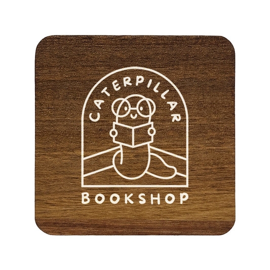 A square wooden coaster with rounded corners, personalised with a book shop business logo in white. Your logo here.