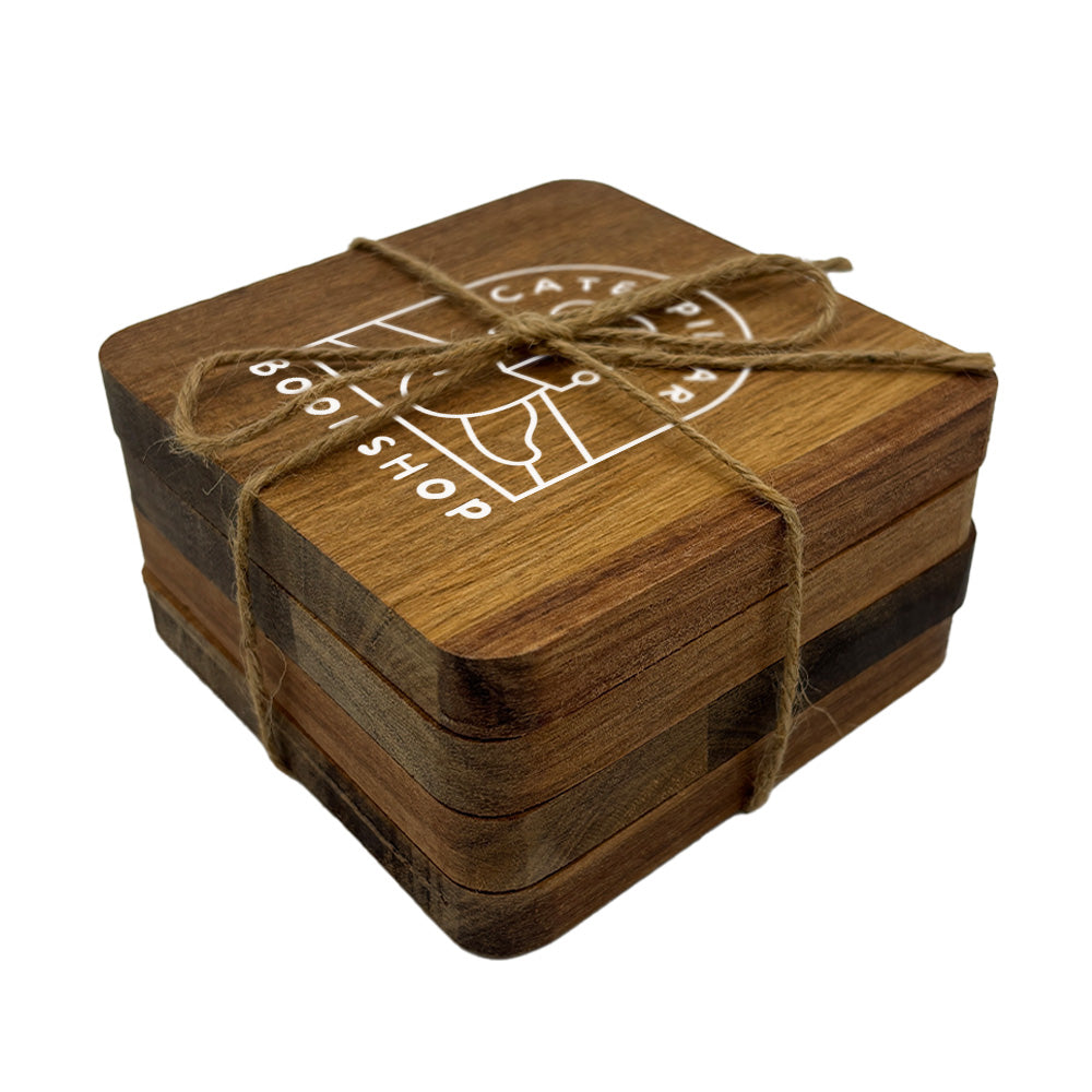 A set of 4 square wooden coasters with rounded corners, personalised with a book shop business logo in white. Your logo here.