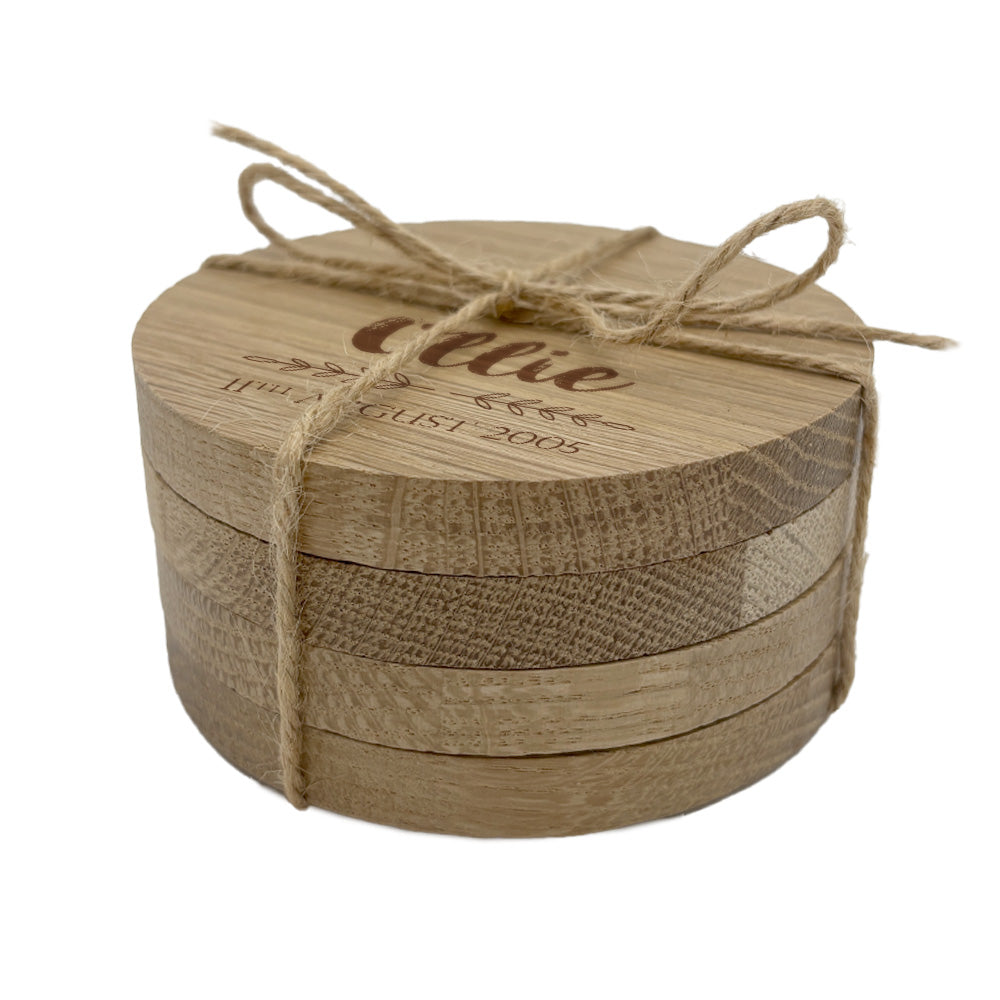 Round wooden coaster set with jute string on a white background