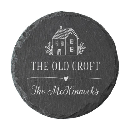 Round personalised house name or number slate coaster, personalised with a house name and family name, with a cute house illustration. 