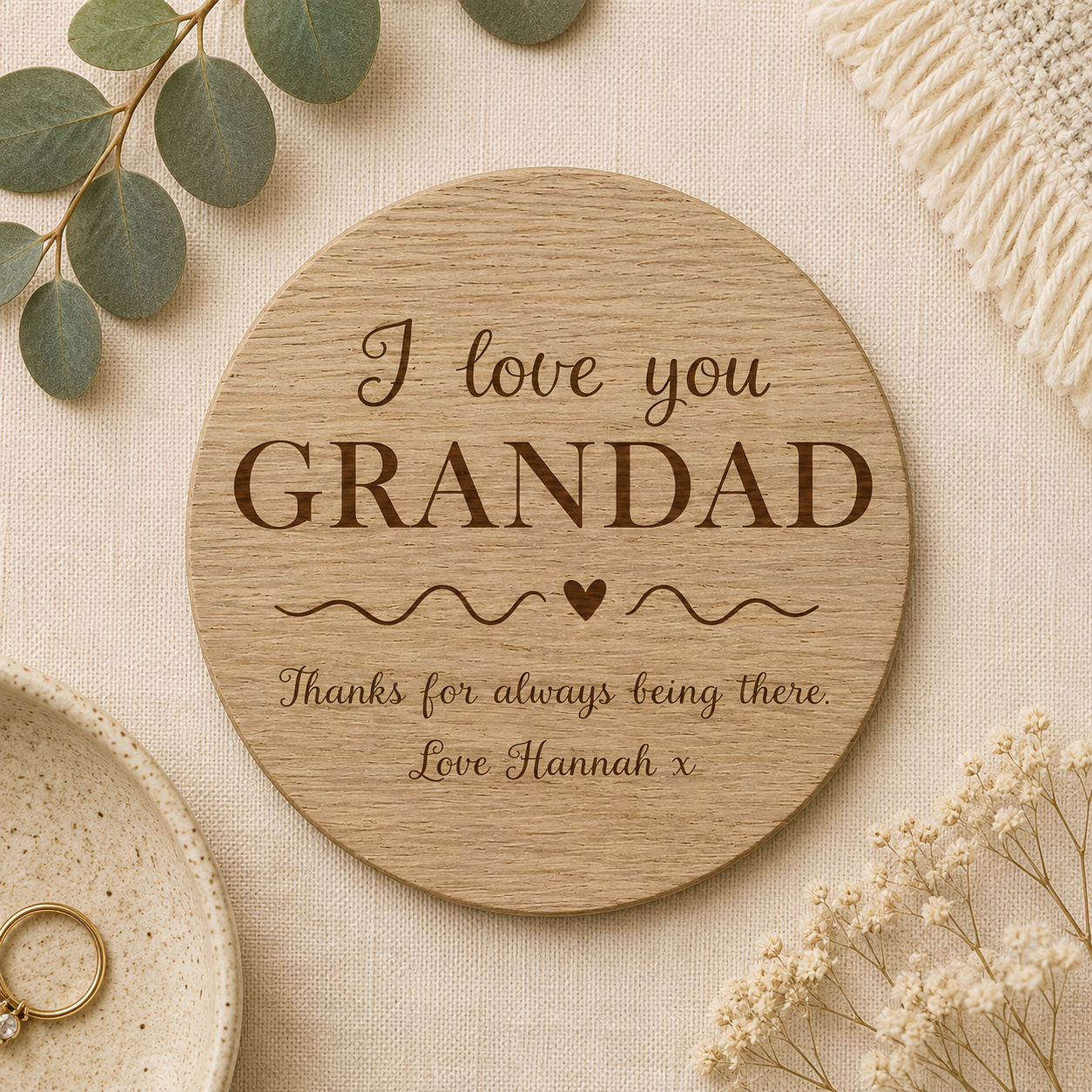 Wooden round coaster with 'I love you GRANDAD' personalised text on a beige background with decorative elements.