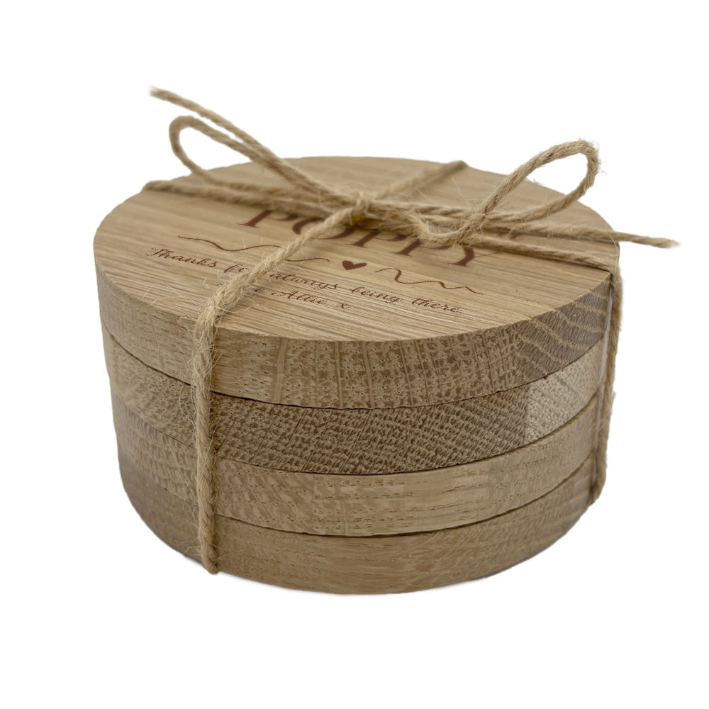 Round wooden coaster set tied with twine on a white background