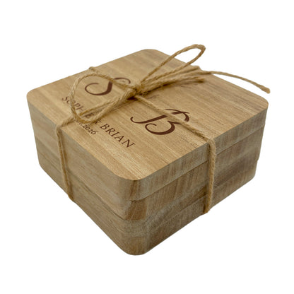 Personalised square wooden coaster set with twine bow on a white background