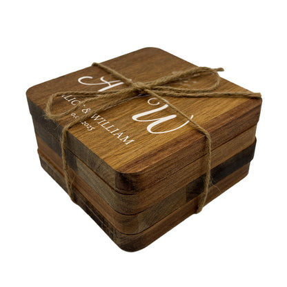 Set of square personalised wooden coasters tied with twine on a white background