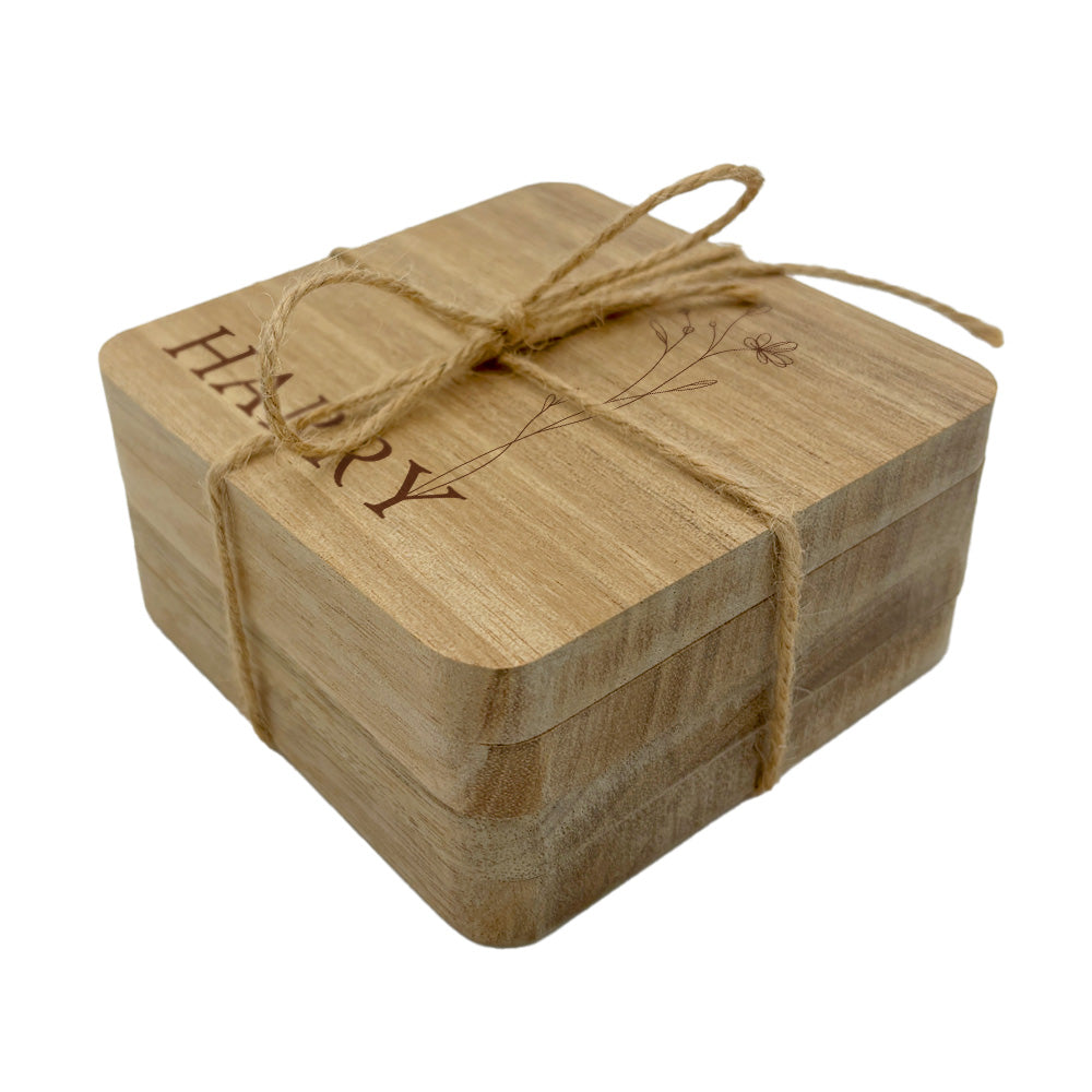 Personalised name set of coasters tied with twine on a white background