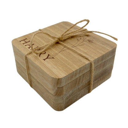 Personalised name set of coasters tied with twine on a white background