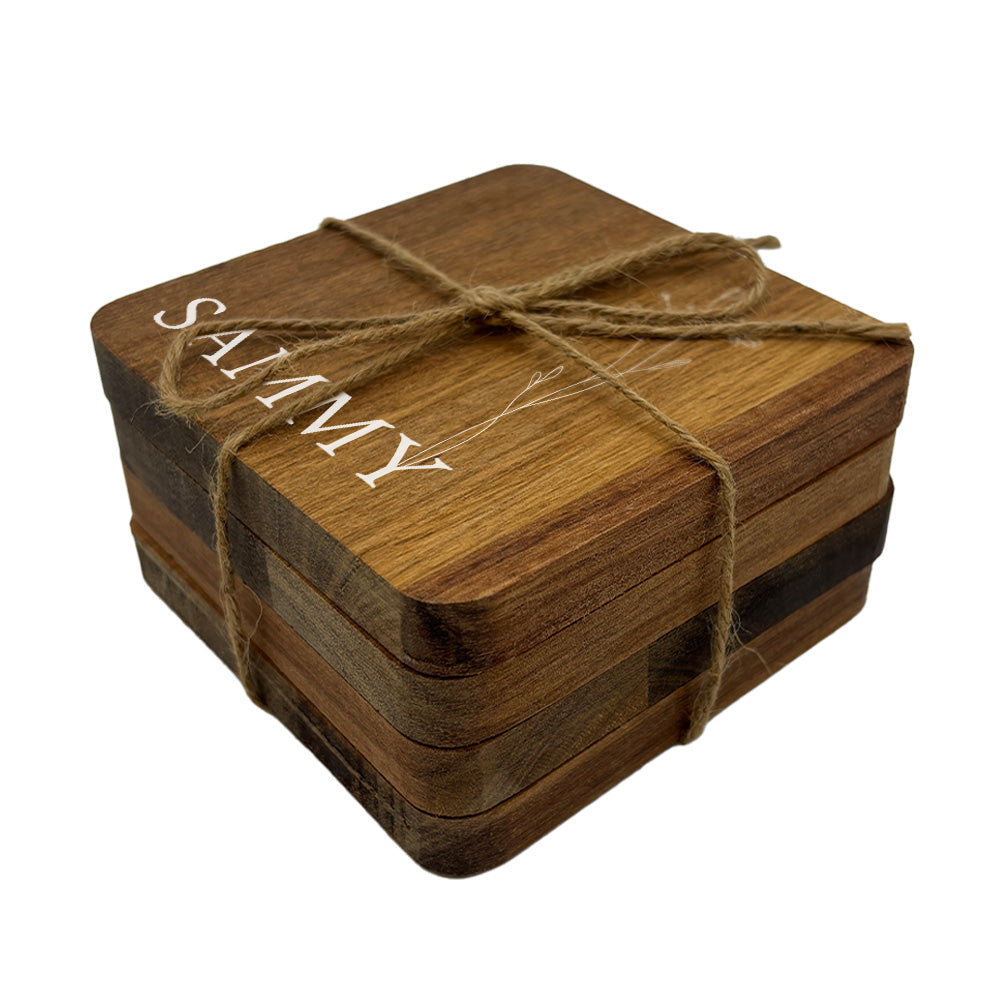 Stack of personalised wooden coasters tied with twine on a white background