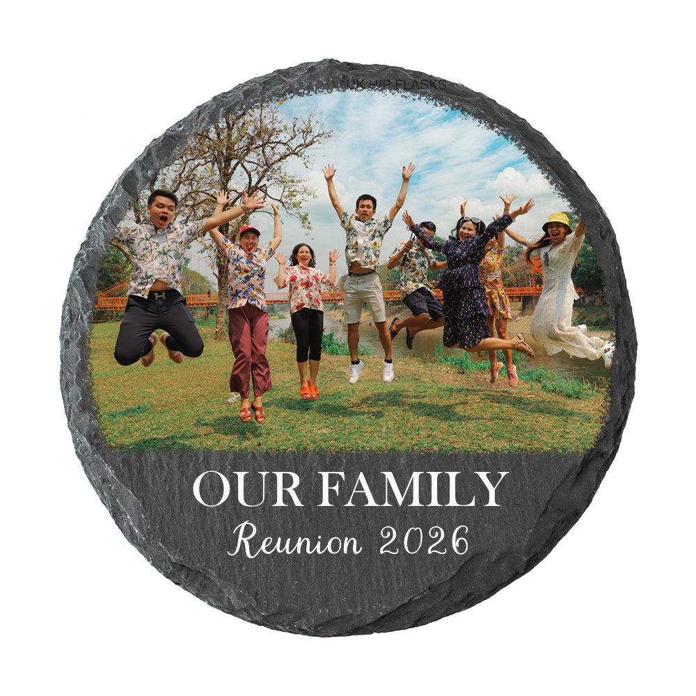 A round slate coaster featuring a custom printed family reunion photo of seven people jumping outdoors, with the text 'OUR FAMILY Reunion 2026' printed on a dark gray background at the bottom.