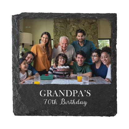 A square dark slate photo coaster, featuring a printed family portrait and the engraved text 'GRANDPA'S 70th Birthday' on a white background.