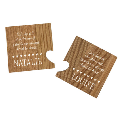 A set of 2 oak wooden coasters with a friendship quote and personalised with best friend's names. When placed together the cut-out on each coaster forms a heart shape.