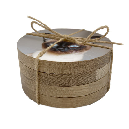 Stack of round coasters personalised with a pet photo, tied with twine on a white background