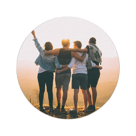 A round wooden coaster personalised with a photo of a group of friends.