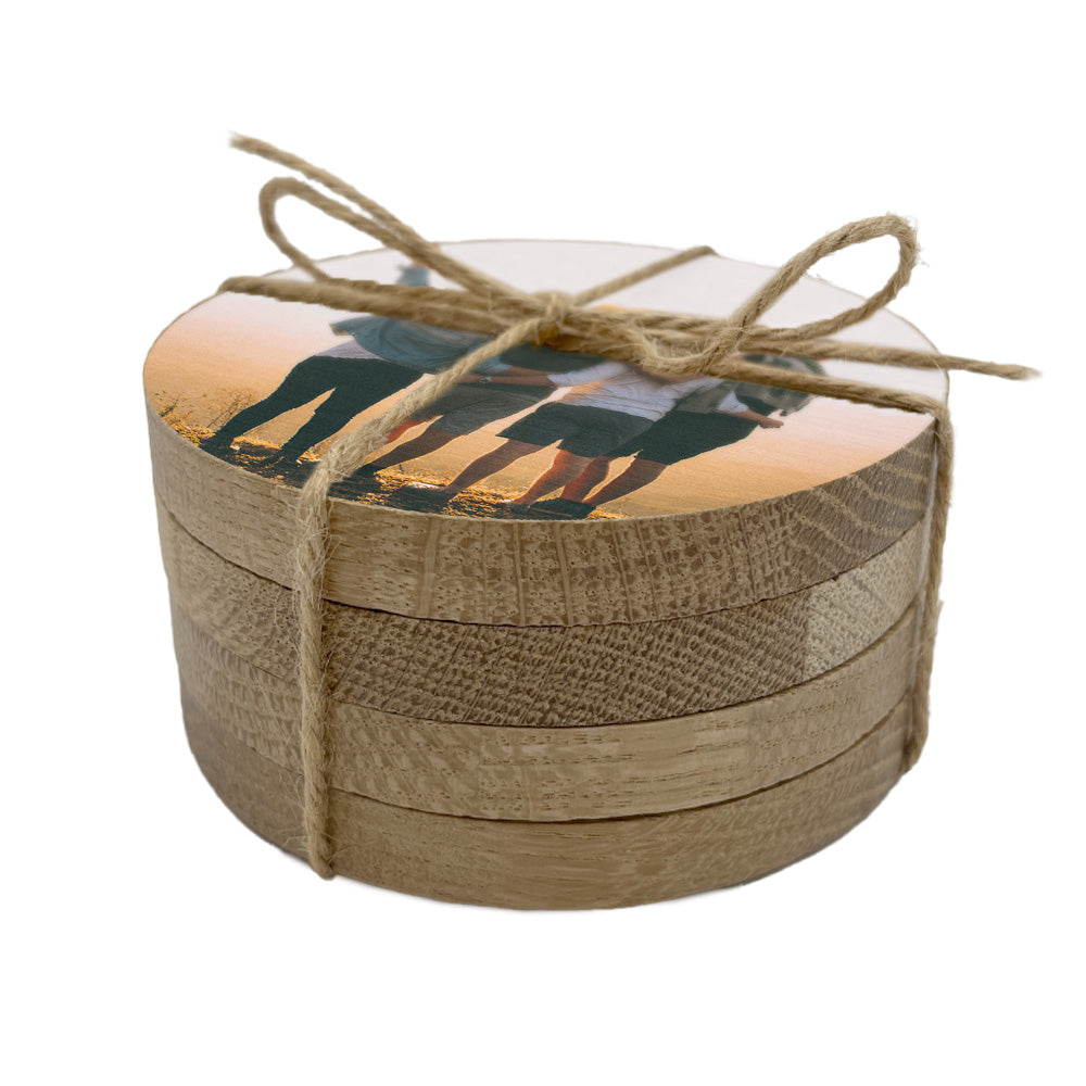 A set of 4 round wooden coasters personalised with a photo of a group of friends.
