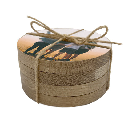 A set of 4 round wooden coasters personalised with a photo of a group of friends.