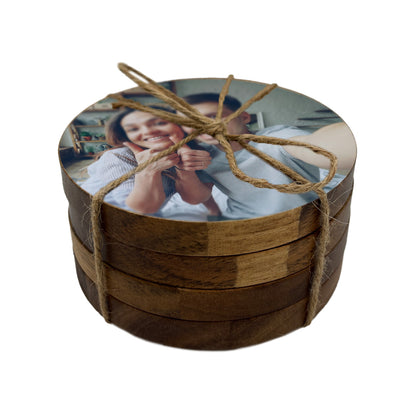 Round wooden coaster set with a personalised photo of a couple, tied with twine.