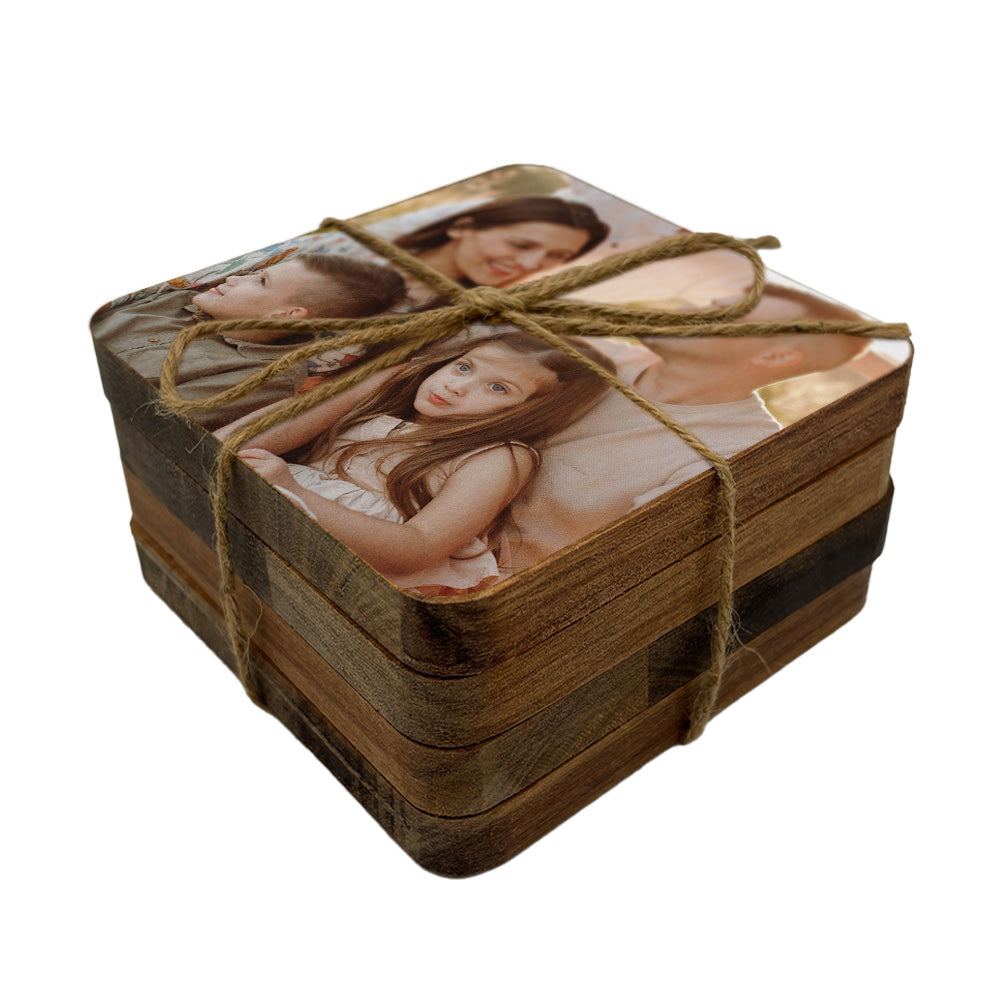 Set of square coasters personalised with a family photo, tied together with twine on a white background.
