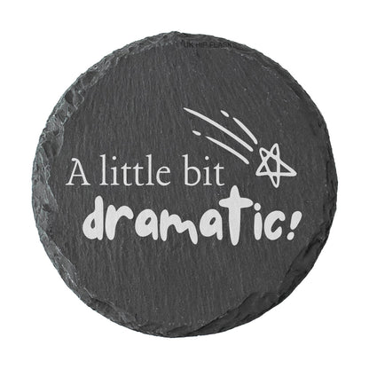 Round slate coaster with 'A little bit dramatic!' text and star design on a white background