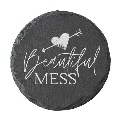Round slate coaster with 'Beautiful Mess' text and heart design on a white background