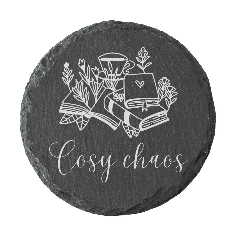 Round slate coaster with the quote "Cosy chaos" in white text.