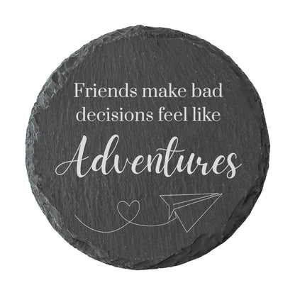 Round slate coaster with humorous quote on a white background