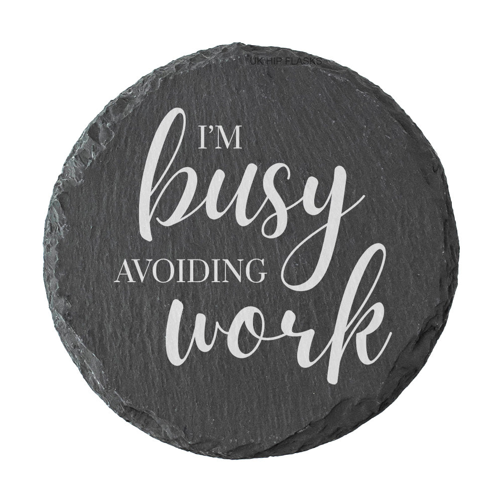Round slate coaster with 'I'm busy avoiding work' text on a white background