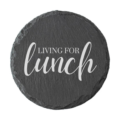 Round slate coaster with 'Living for lunch' text on a white background