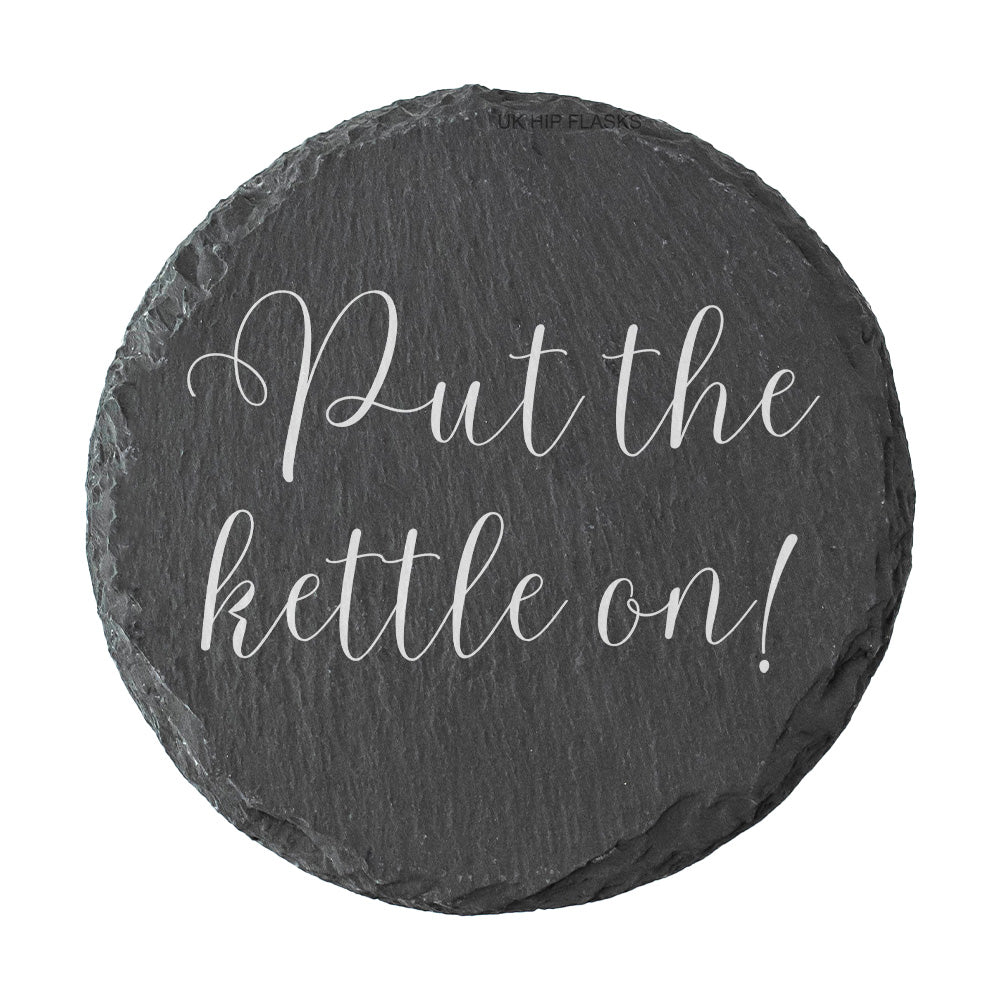 Round slate coaster with 'Put the kettle on!' text on a white background