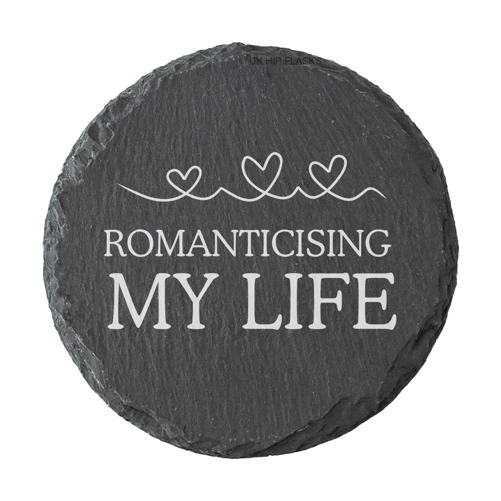 Round slate coaster with 'Romanticising My Life' text and heart designs on a white background