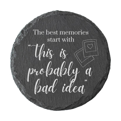 Round slate coaster with "The best memories start with this is probably a bad idea" quote on a white background
