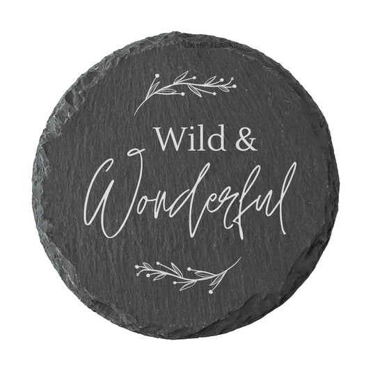 Round slate coaster with 'Wild & Wonderful' text and leaf designs on a white background