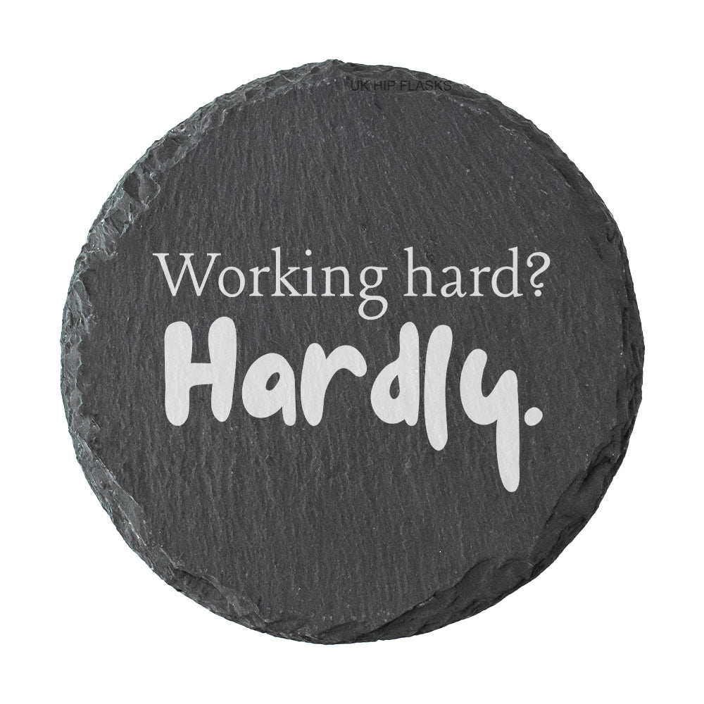 Round slate coaster with motivational quote 'Working hard? Hardly.' on a white background