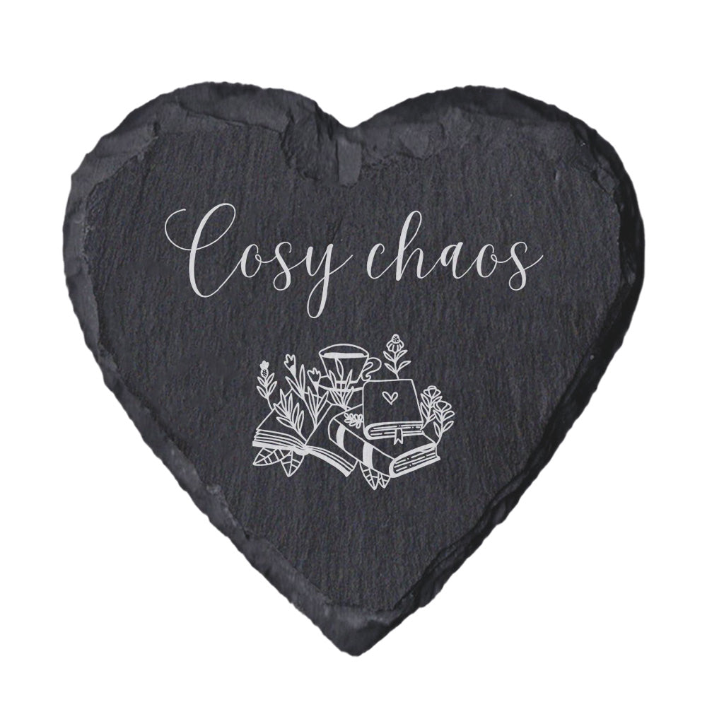 Heart-shaped slate coaster with 'Cosy chaos' text and illustrations on a white background