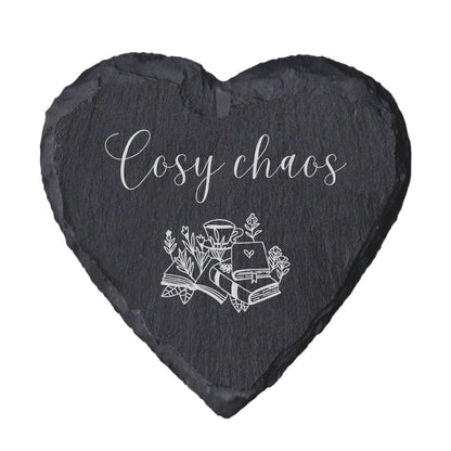 Heart-shaped slate coaster with 'Cosy chaos' text and illustrations on a white background